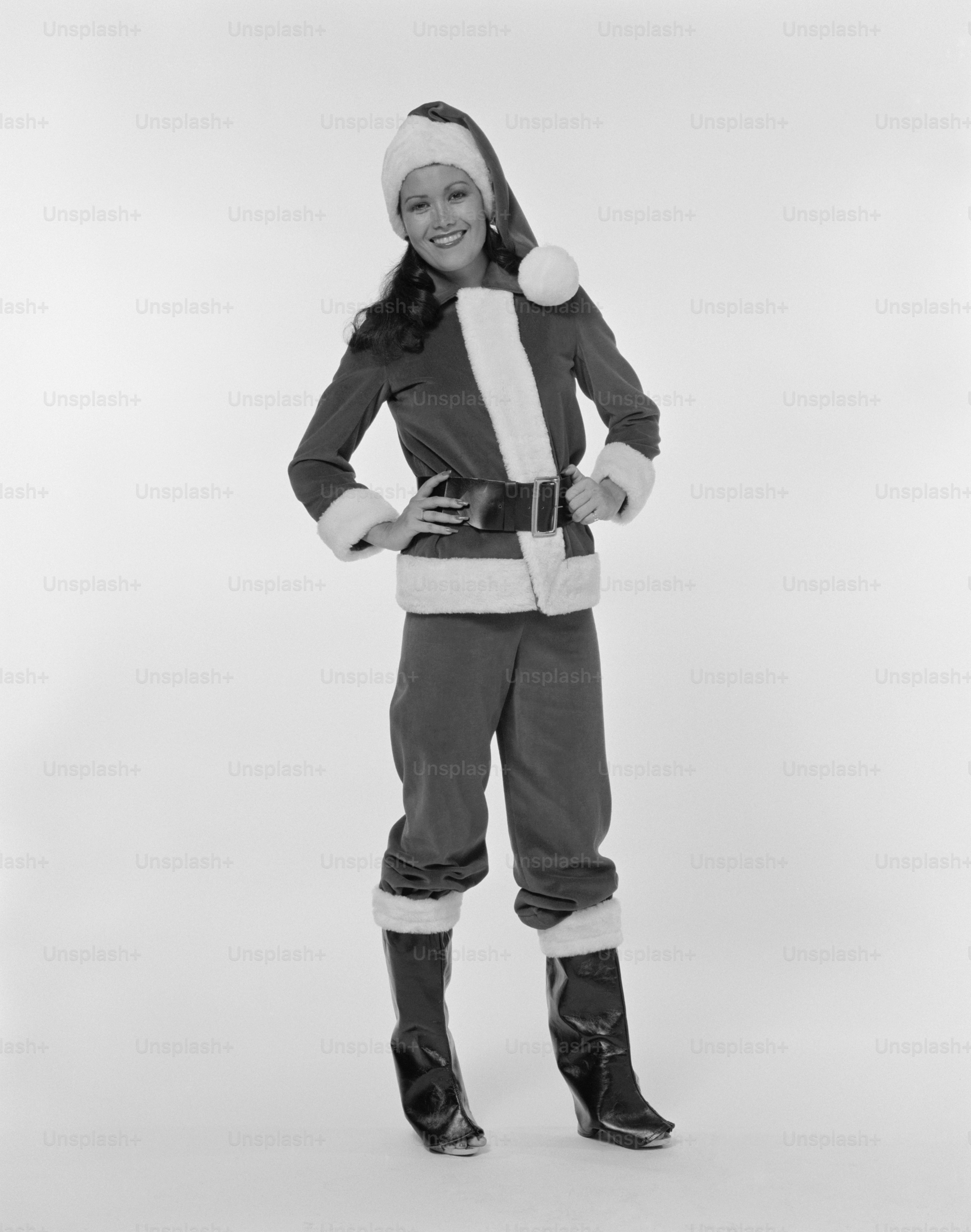 a woman in a snowsuit and hat posing for a picture