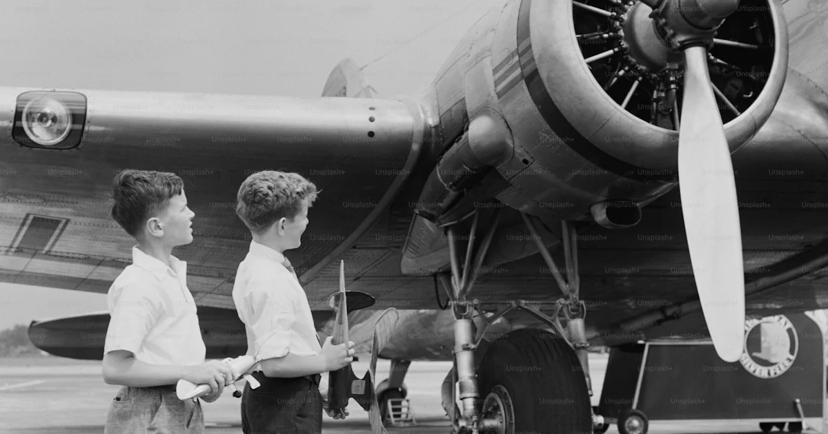 UNITED STATES CIRCA 1940s Two Boys Standing Next To Propeller united-states-circa-1940s-two-boys-standing-next-to-propeller