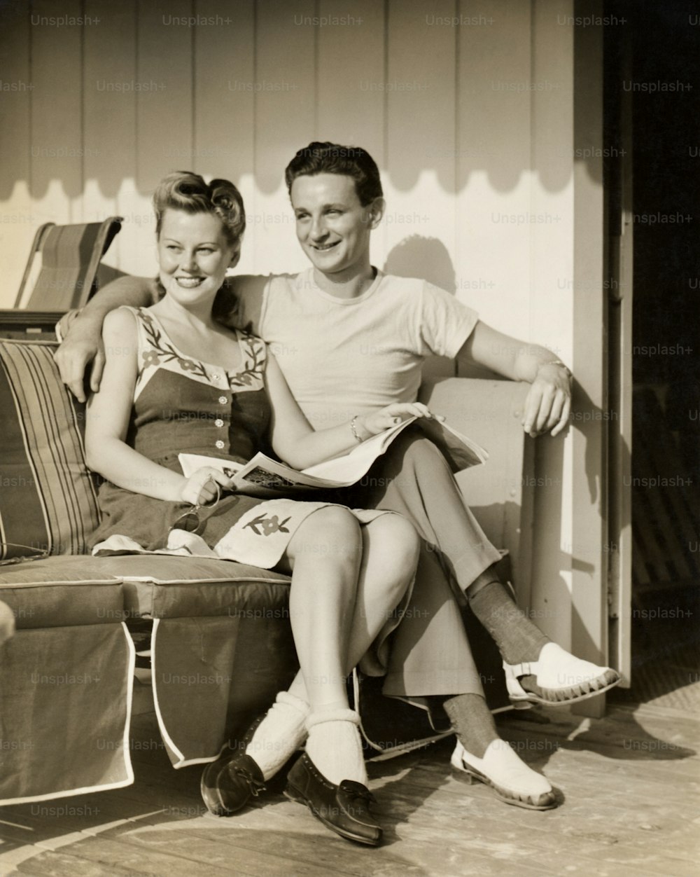 UNITED STATES - CIRCA 1950s:  Couple sitting outside.