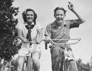 A young man and woman riding bicycles. (Photo by George Marks/Retrofile/Getty Images)