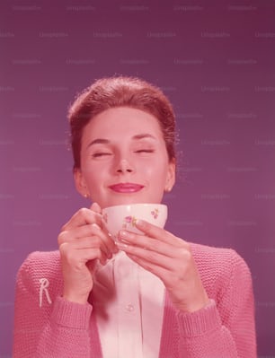 UNITED STATES - CIRCA 1960s:  Woman drinking hot beverage.