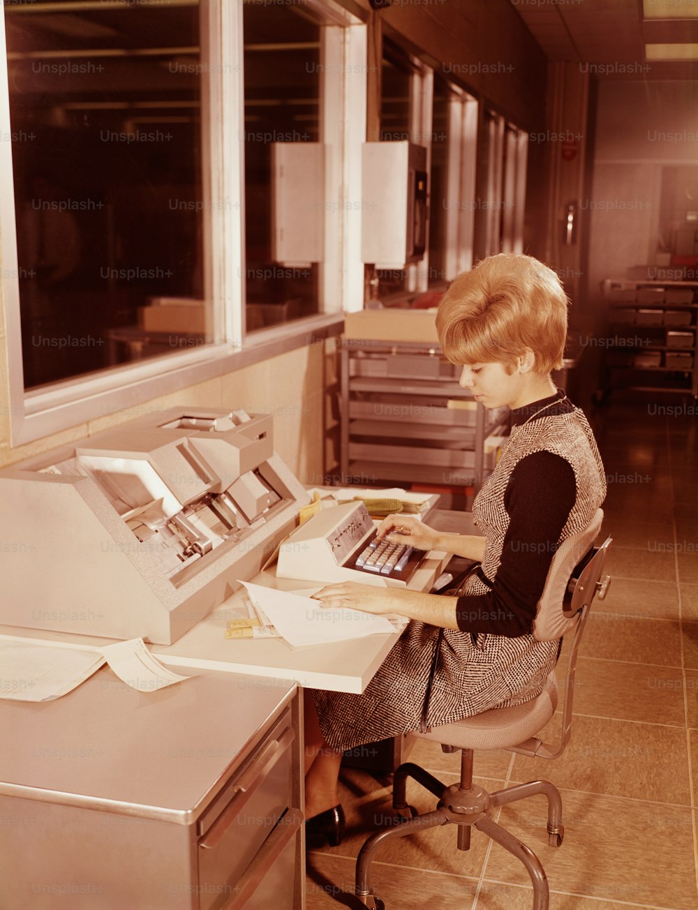 UNITED STATES - CIRCA 1970s:  Woman seated at keyboard.