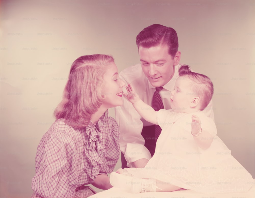 UNITED STATES - CIRCA 1950s:  Couple with baby, portrait.