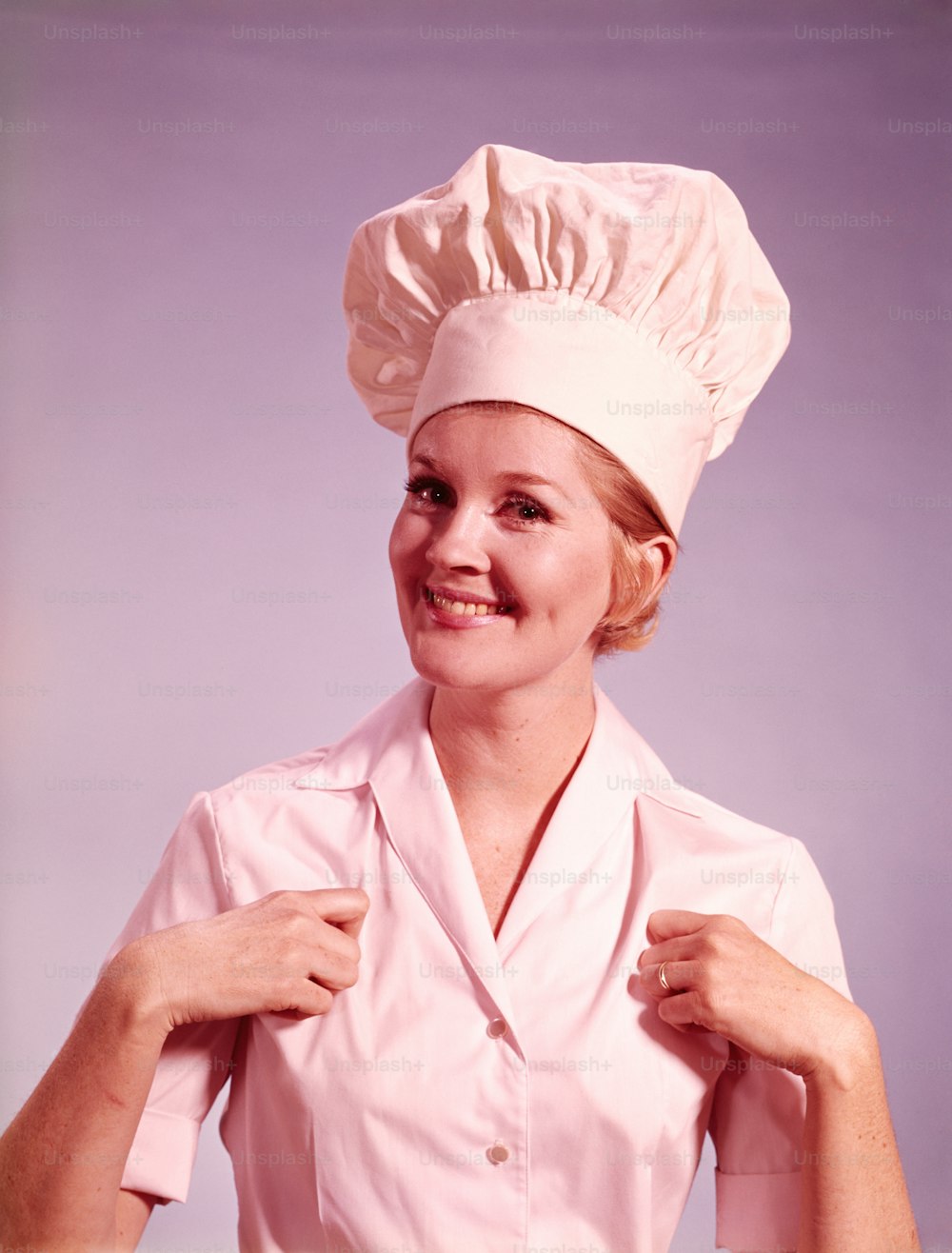 UNITED STATES - CIRCA 1960s:  Female chef smiling and gesturing thumbs up.