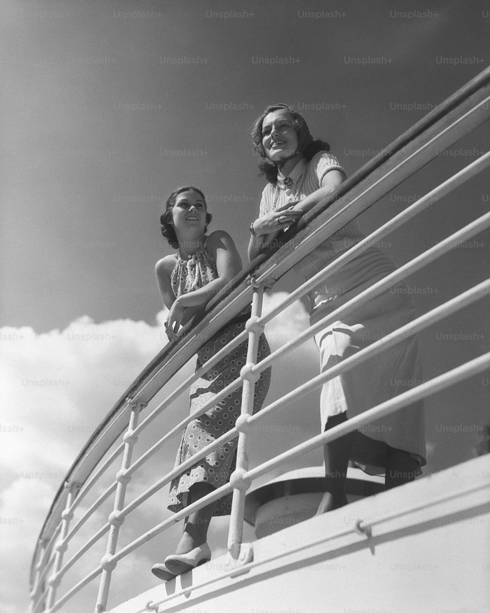 UNITED STATES - CIRCA 1930s:  Two women standing by railing on cruise ship.
