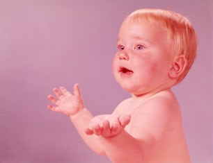 UNITED STATES - CIRCA 1950s:  Baby holding hands up.