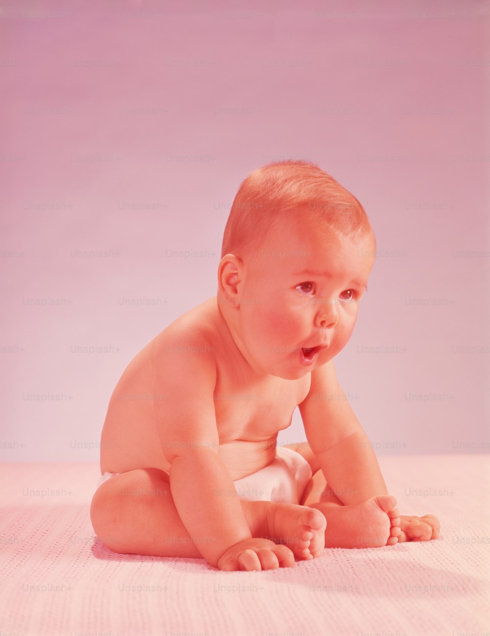 UNITED STATES - CIRCA 1950s:  Baby wearing nappy, leaning forwards.