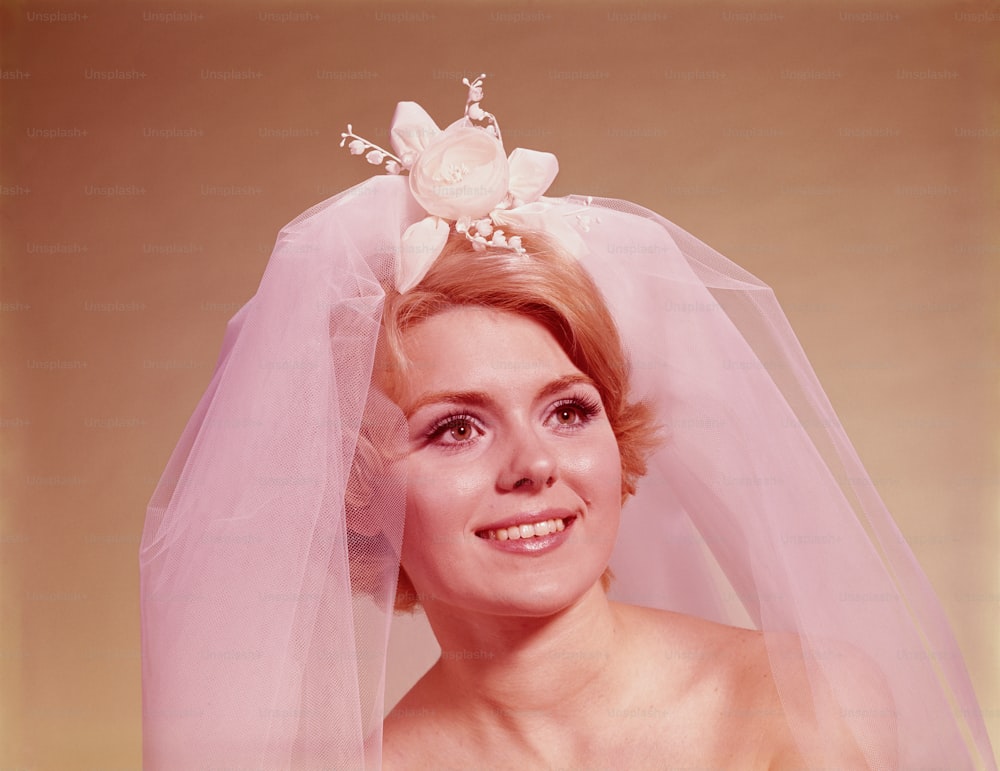 UNITED STATES - CIRCA 1960s:  Portrait of bride wearing veil.