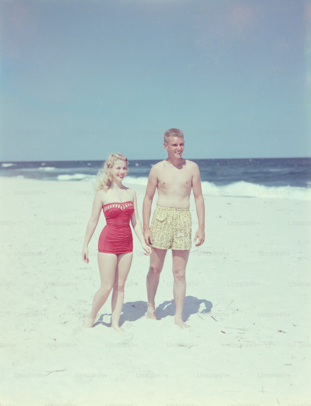 UNITED STATES - CIRCA 1950s:  Teenage couple on beach.