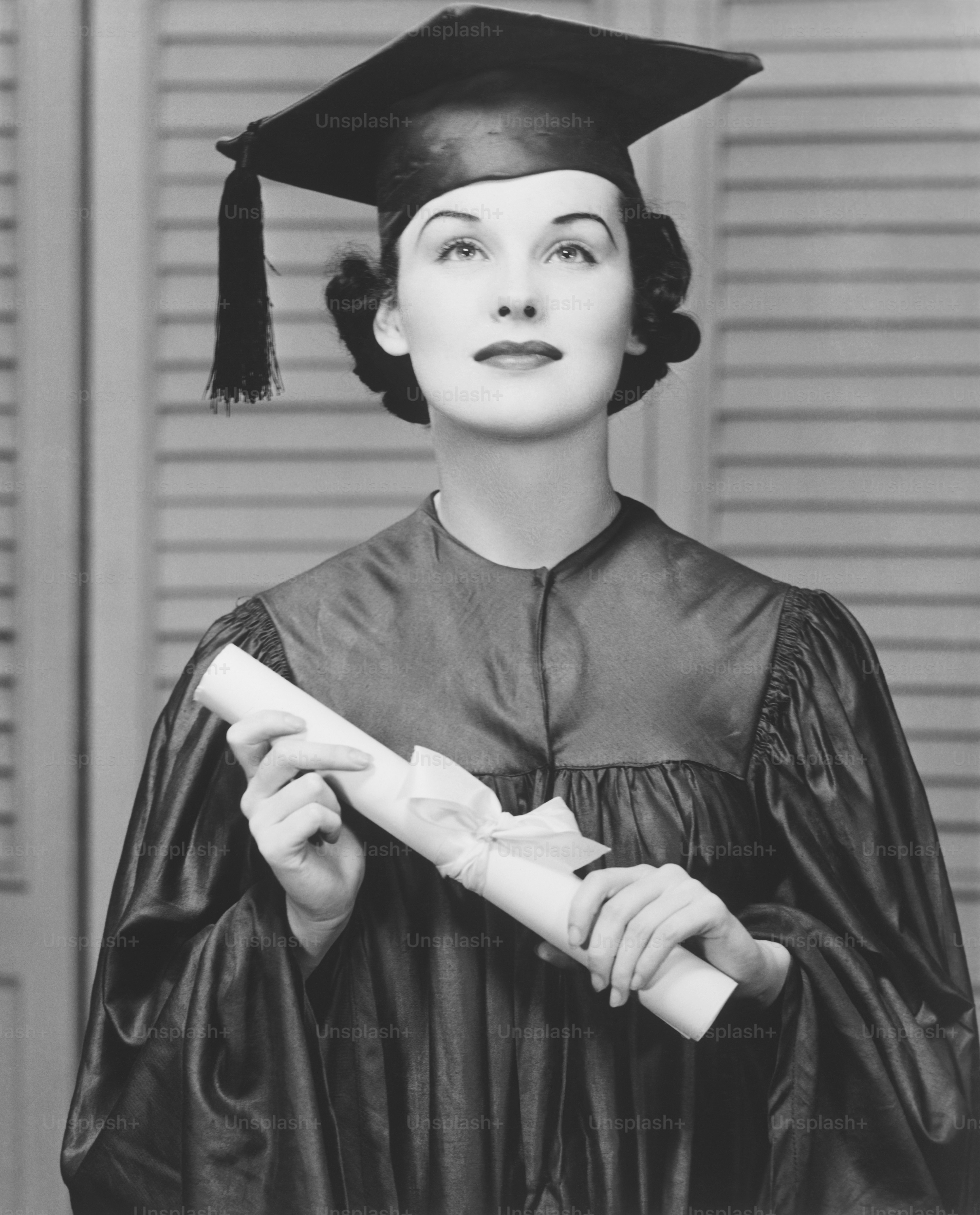 a woman in a graduation gown holding a diploma