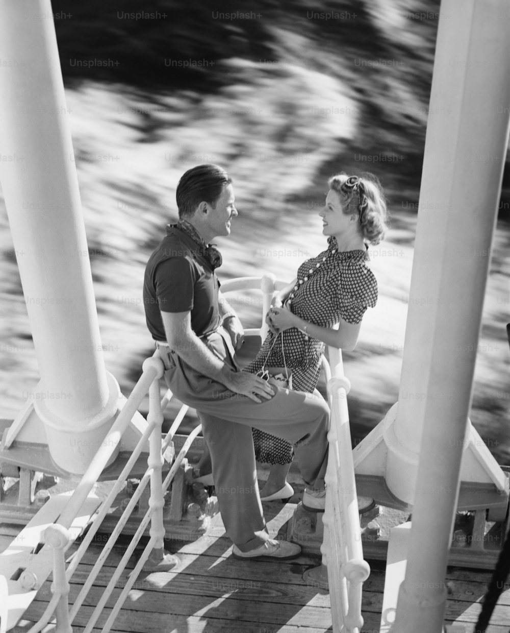 a man and a woman sitting on a dock