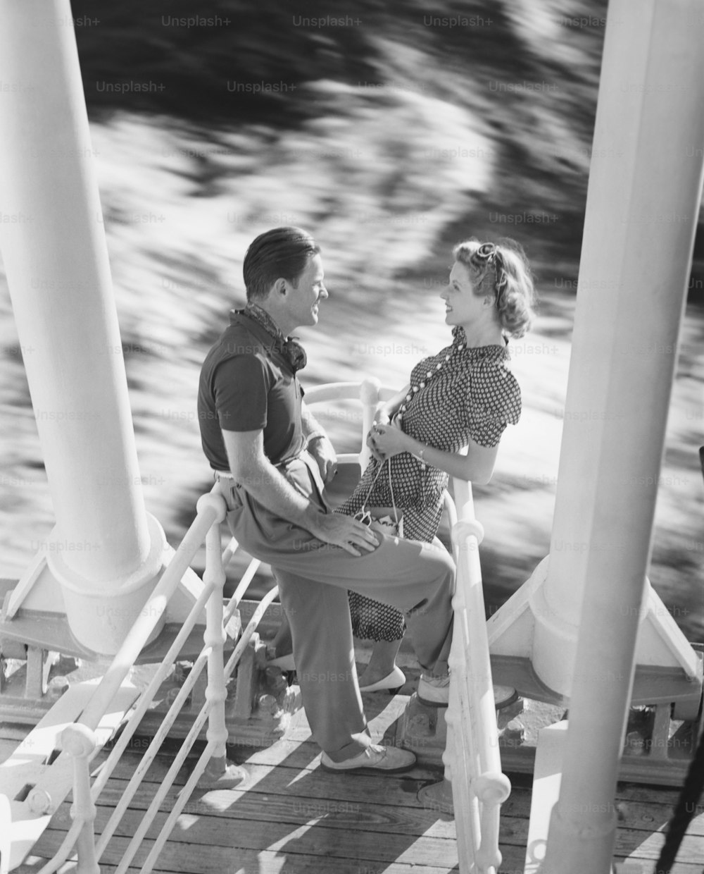 a man and a woman sitting on a dock