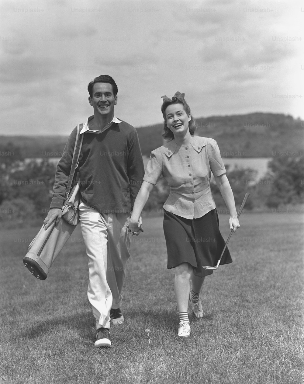 a man and a woman walking in a field