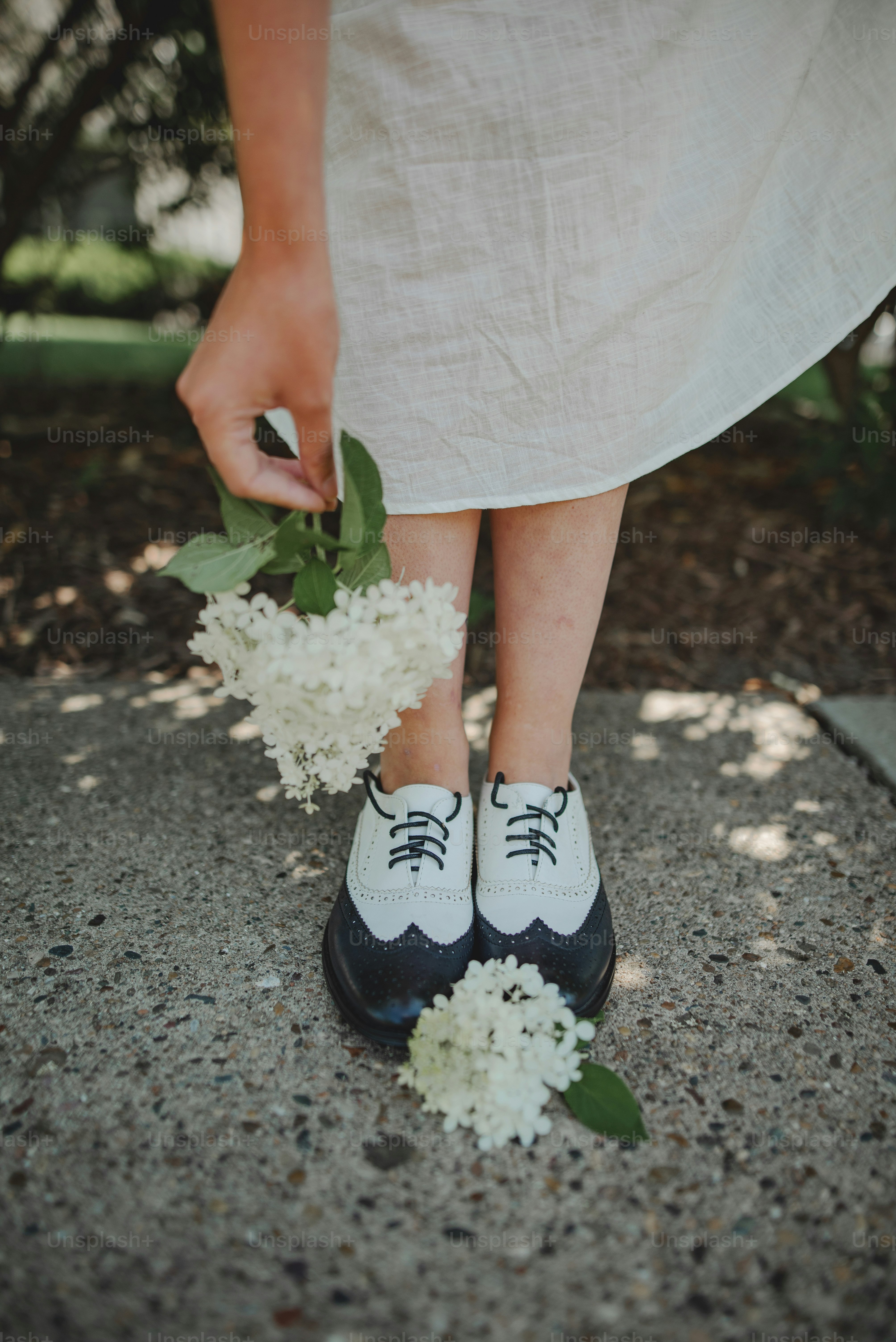 a close up of a person wearing black and white shoes