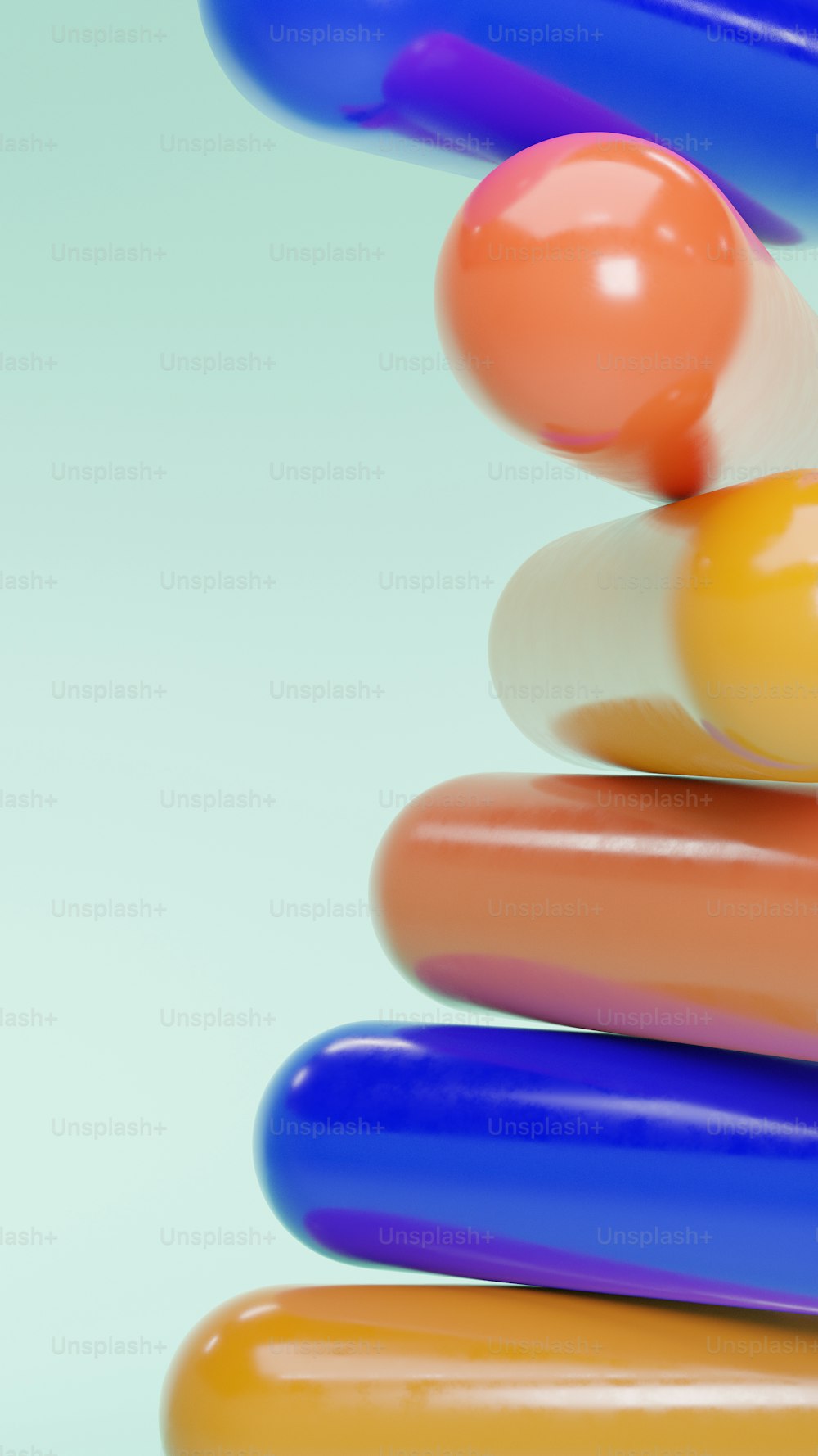 a stack of different colored pills on a white background