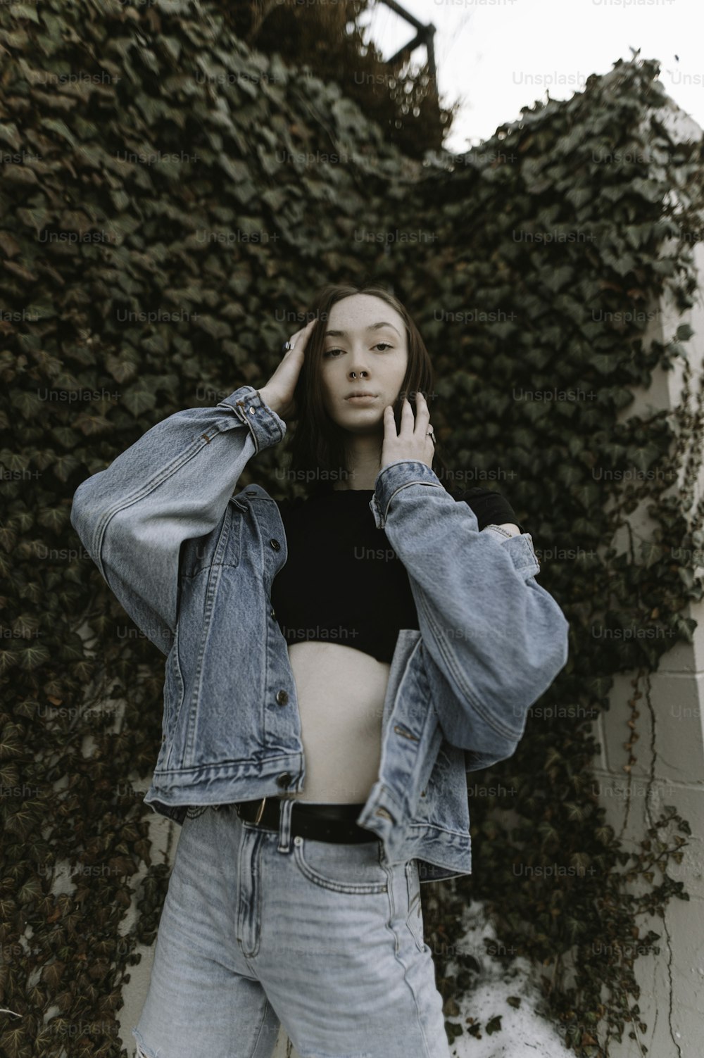 a woman in a crop top and jean jacket