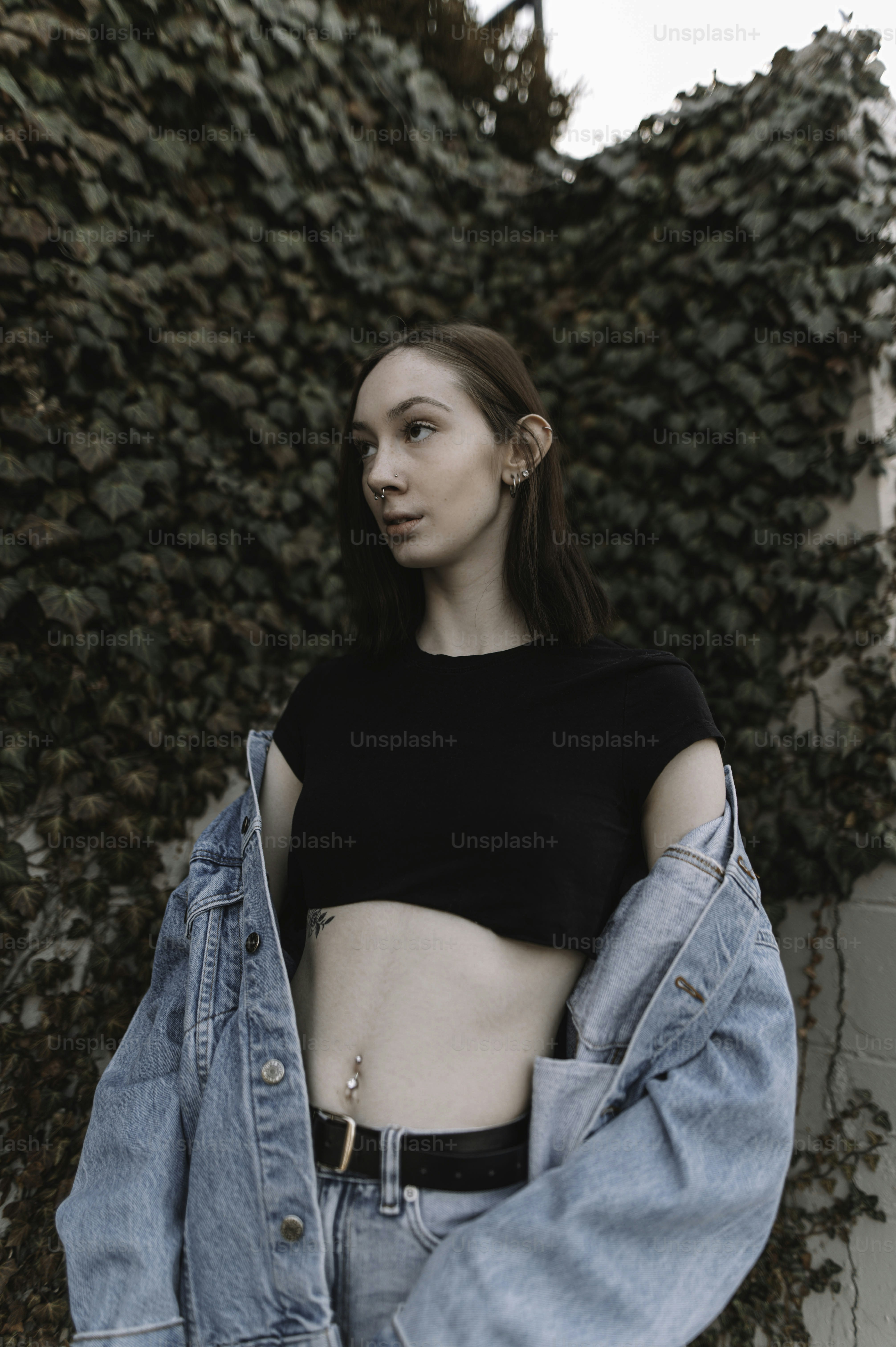 a woman in a black shirt and jean jacket