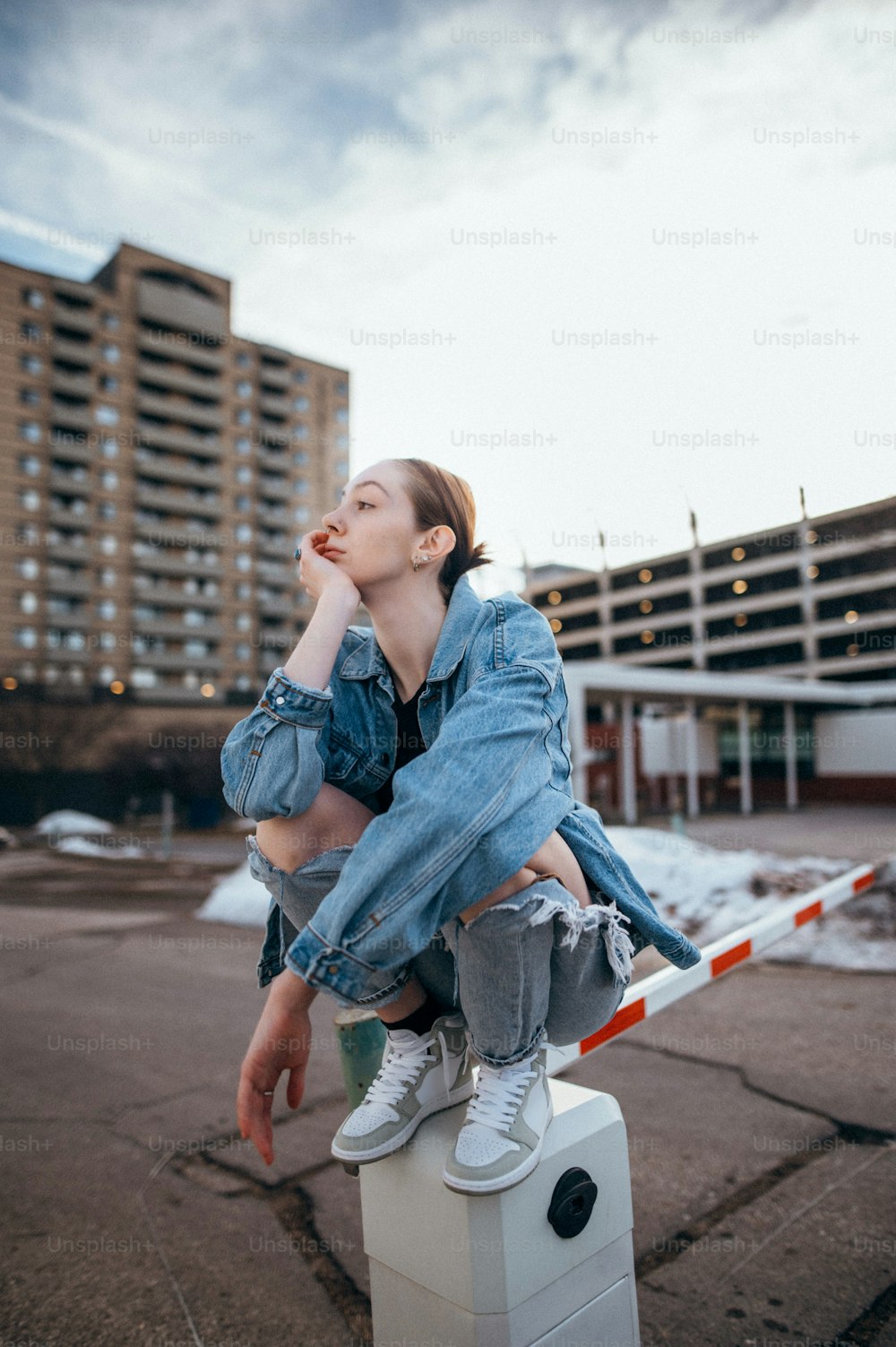 a woman sitting on top of a white box