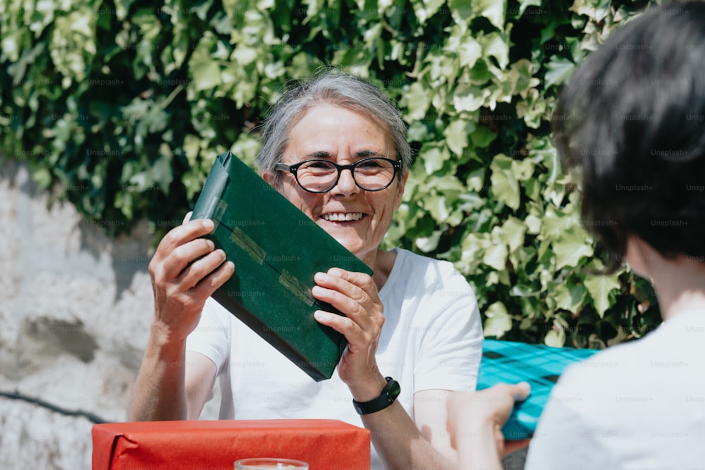 a woman holding a green folder in front of a woman