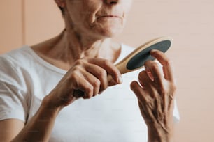 a woman holding a wooden paddle in her right hand