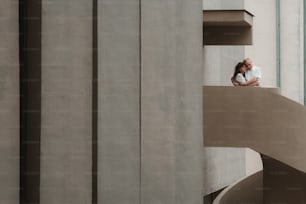 a man standing on a ledge next to a building