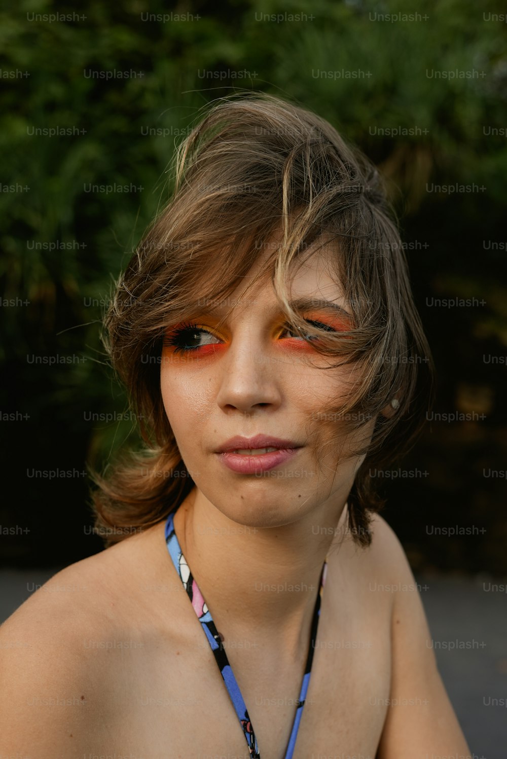 a woman wearing a necklace with flowers on it