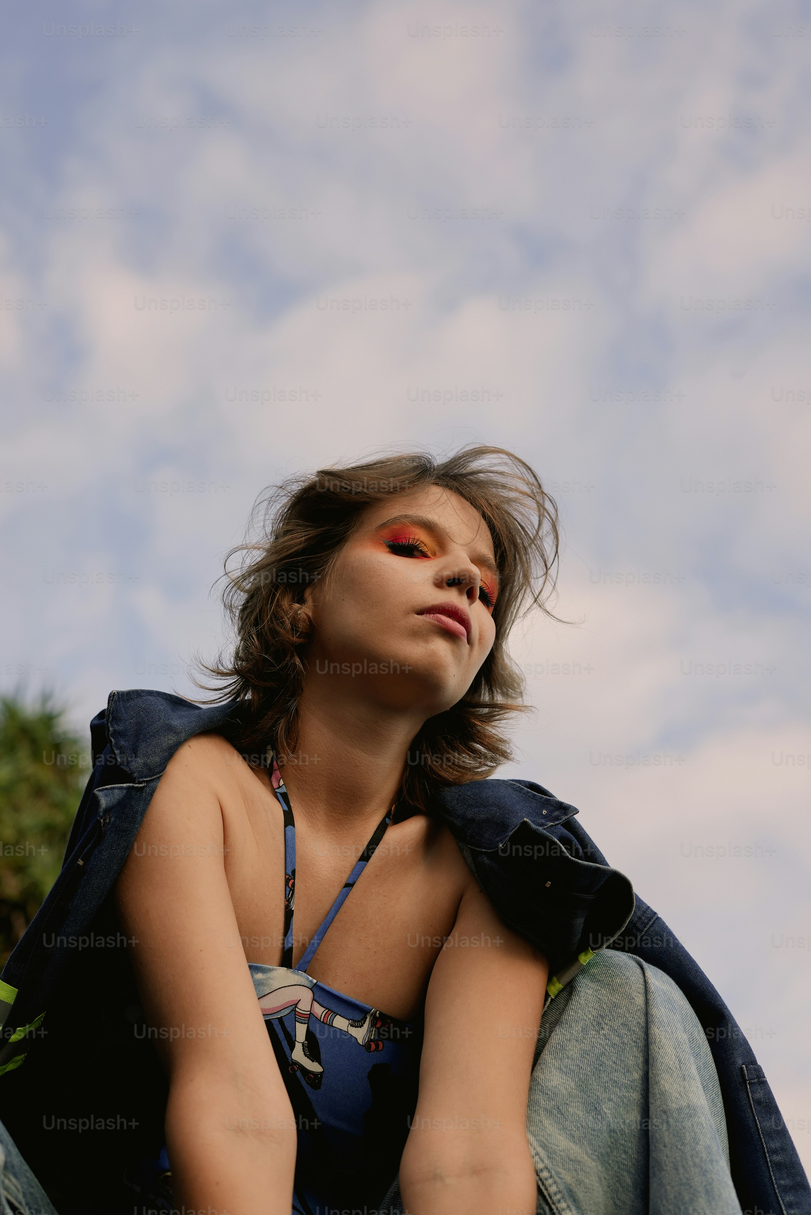 a woman sitting on the ground with her eyes closed
