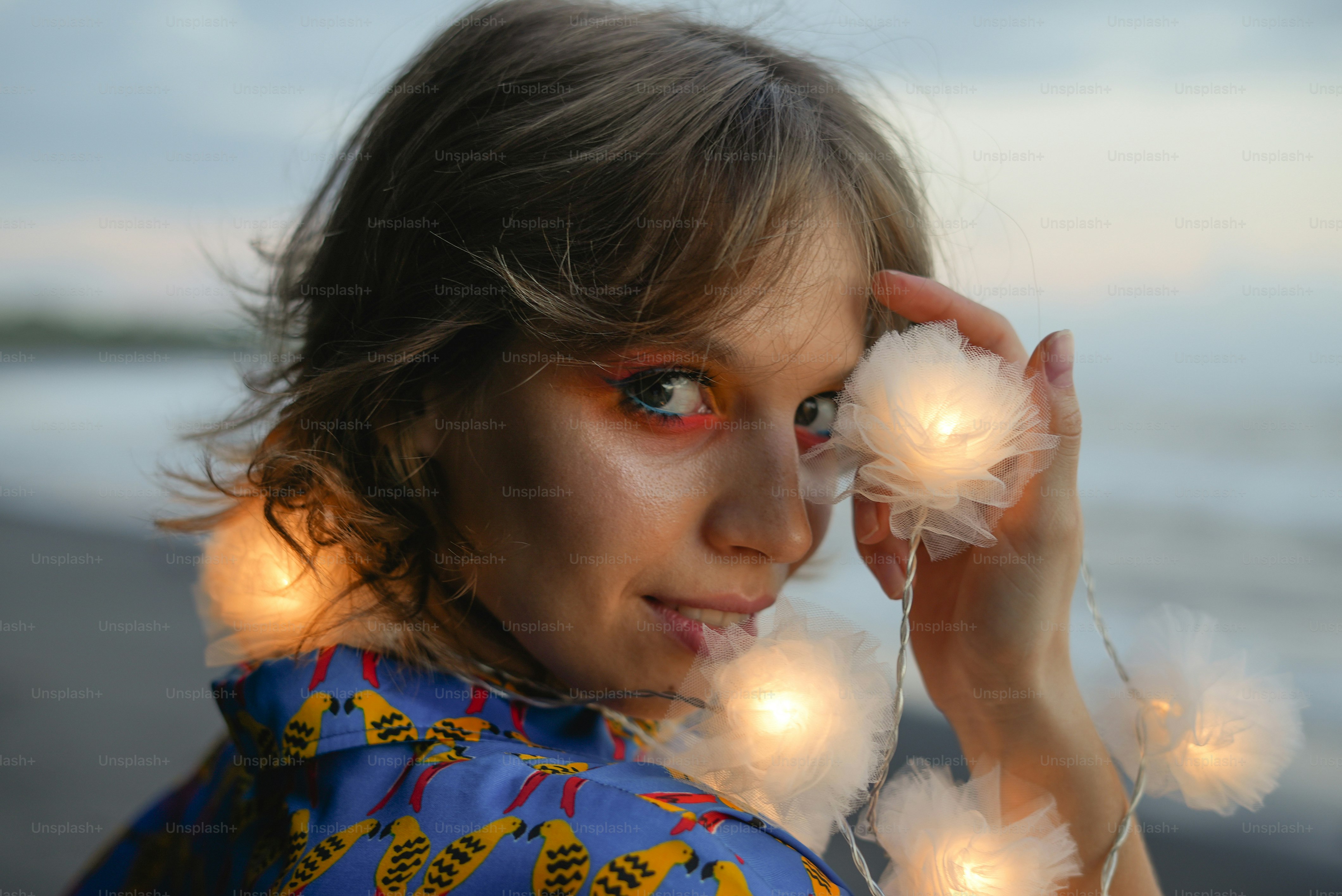 a woman with makeup and feathers on her face