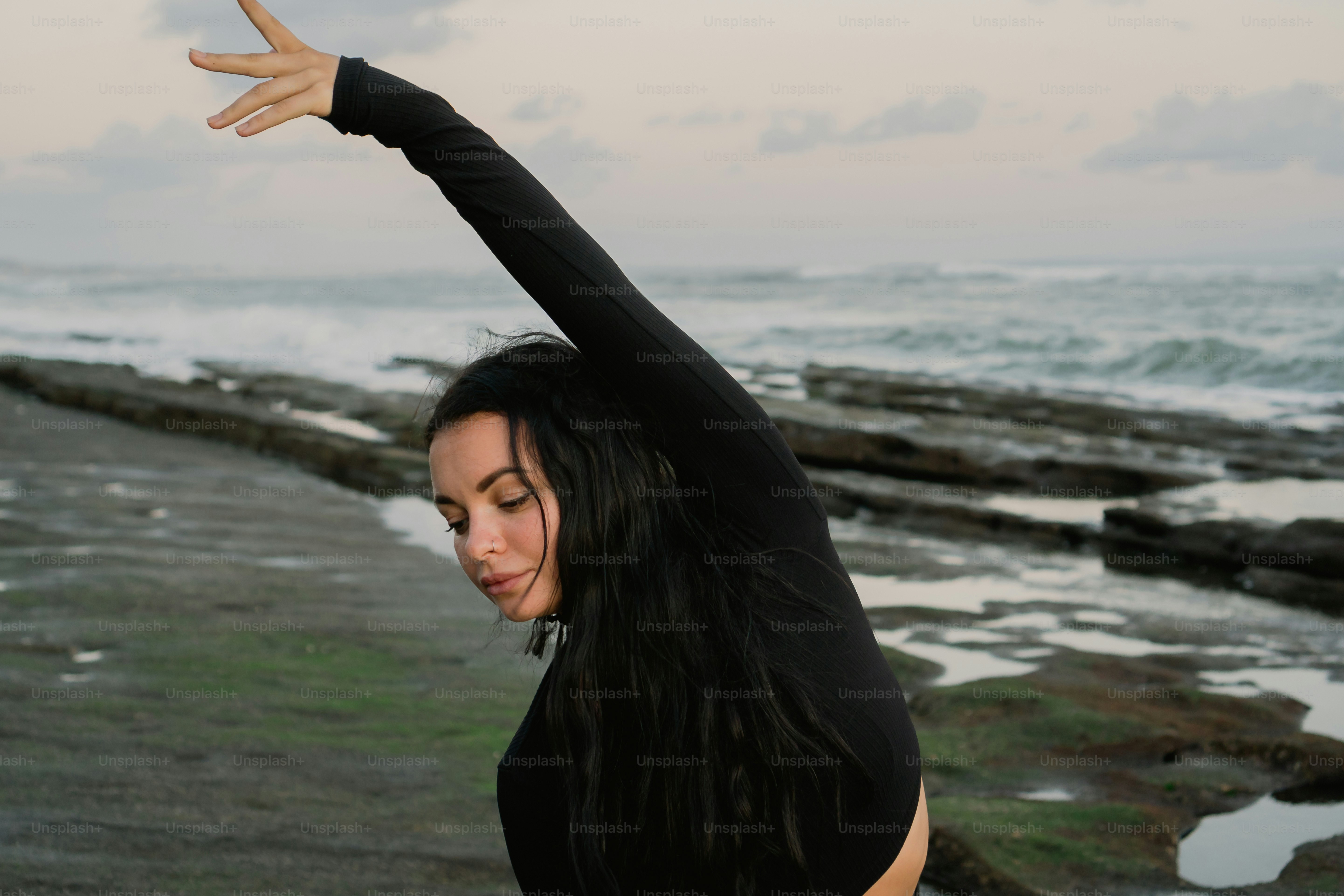 A woman doing a yoga pose on the beach photo – Beach Image on Unsplash