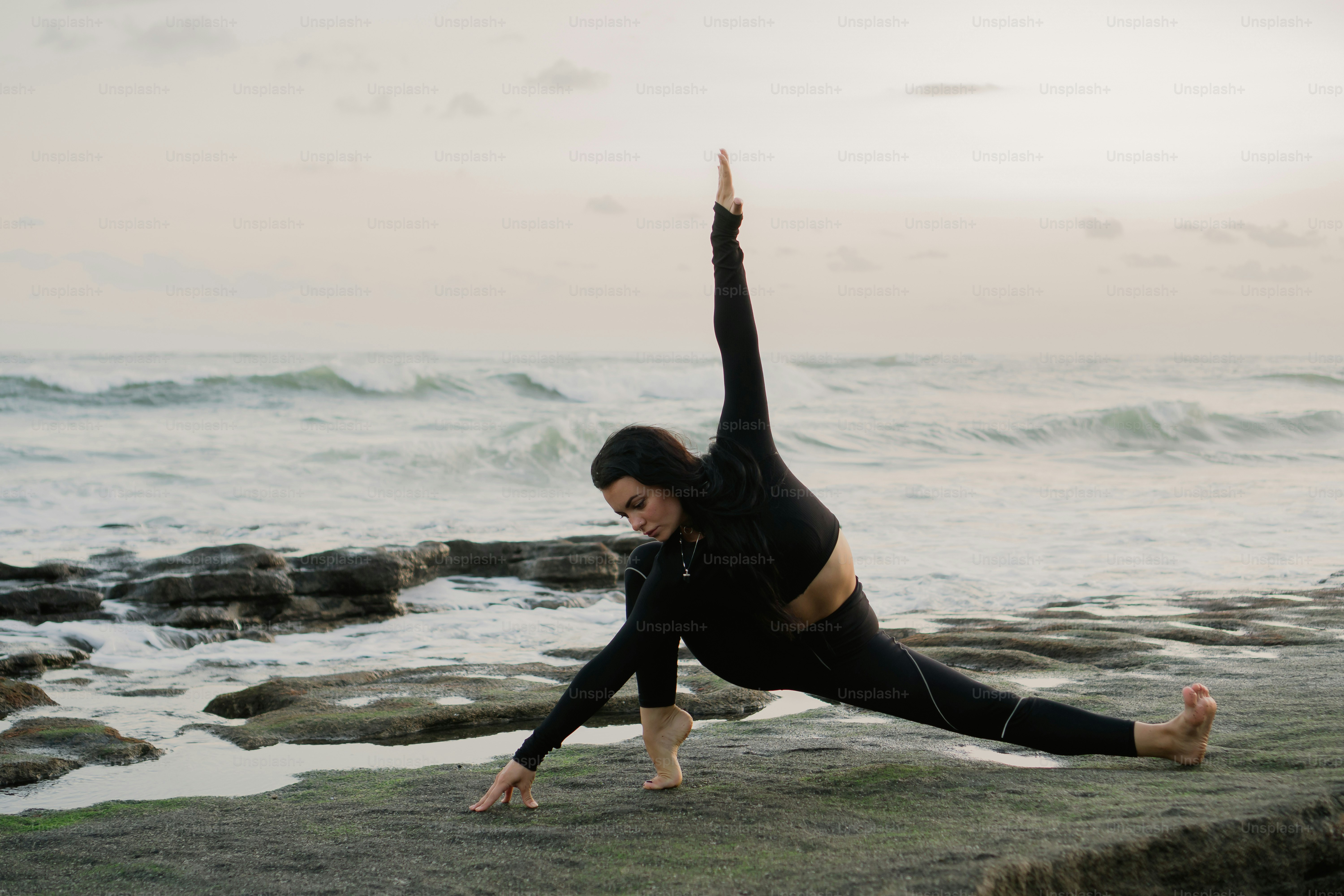 A woman doing a yoga pose on the beach photo – People in nature Image ...