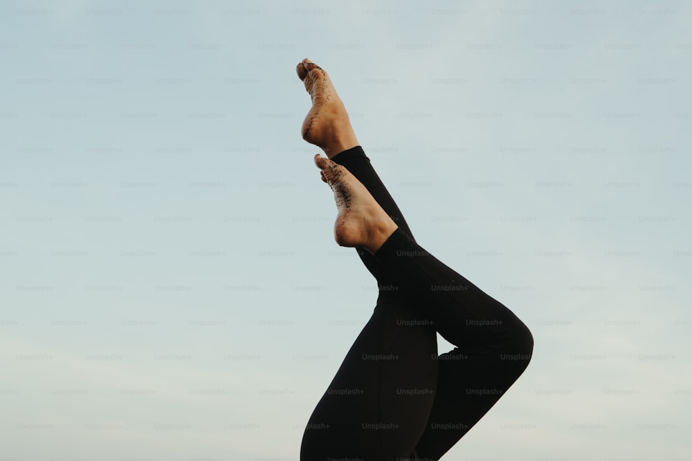 une personne faisant une pose de yoga sur une plage