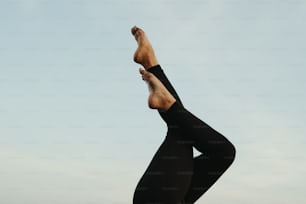 a person doing a yoga pose on a beach
