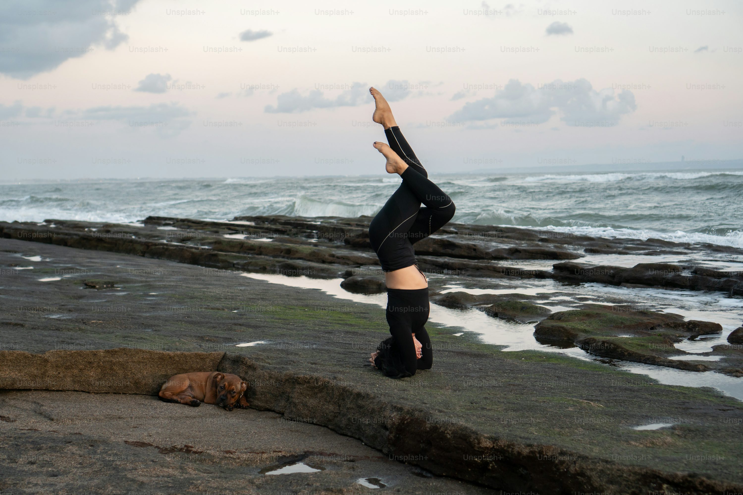 a woman doing a handstand in front of the ocean, personal growth
