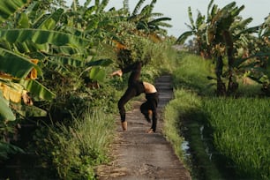 a person doing a handstand on a dirt road