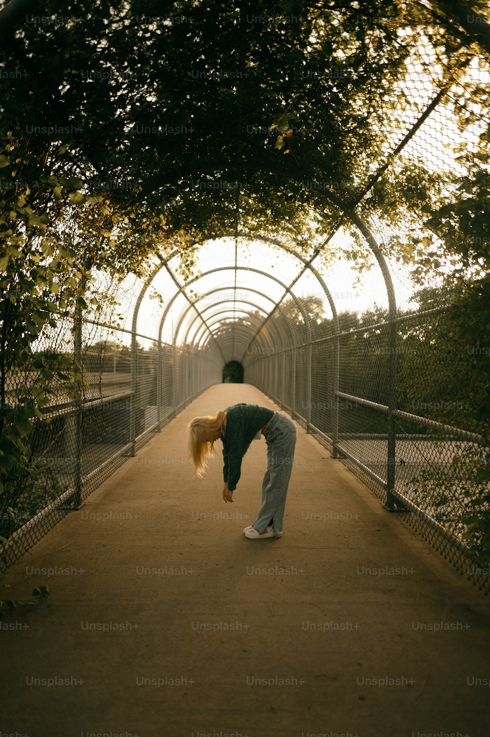 a person doing a handstand on a walkway