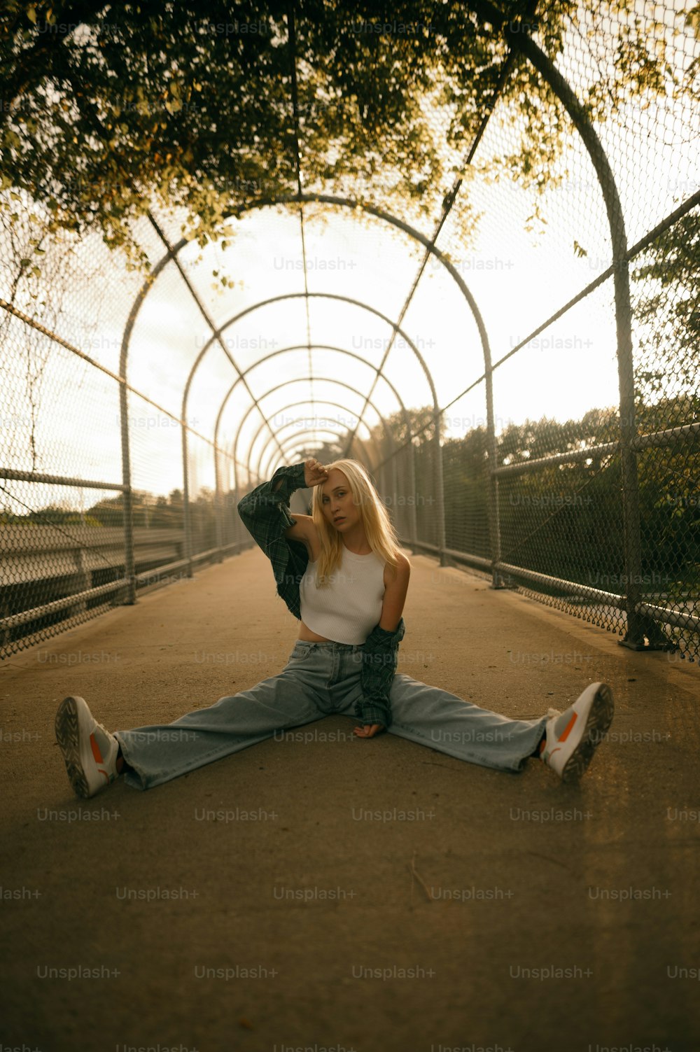 a woman sitting on the ground with her legs crossed