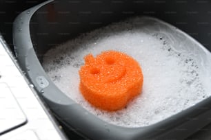 a bathtub filled with foam next to a keyboard