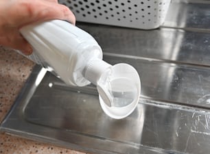 a person is filling a container with water