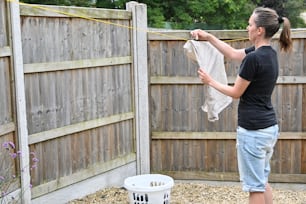 a woman in a black shirt is holding a cloth