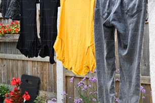 clothes hanging on a clothes line in front of a fence