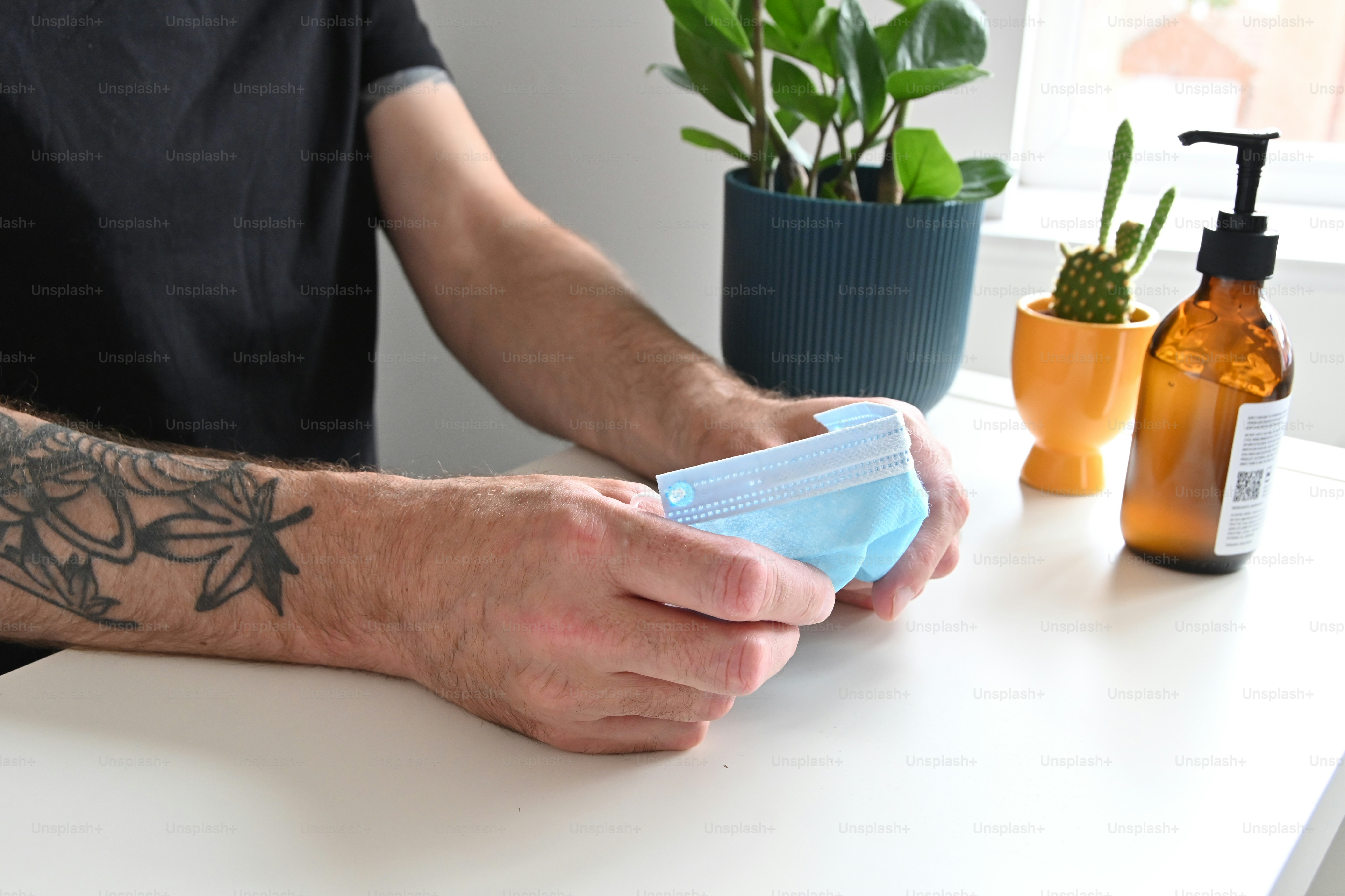 a man with a tattoo on his arm is cleaning a table