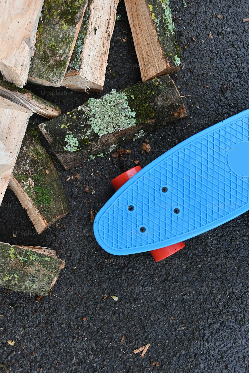 a blue and red skateboard laying on the ground