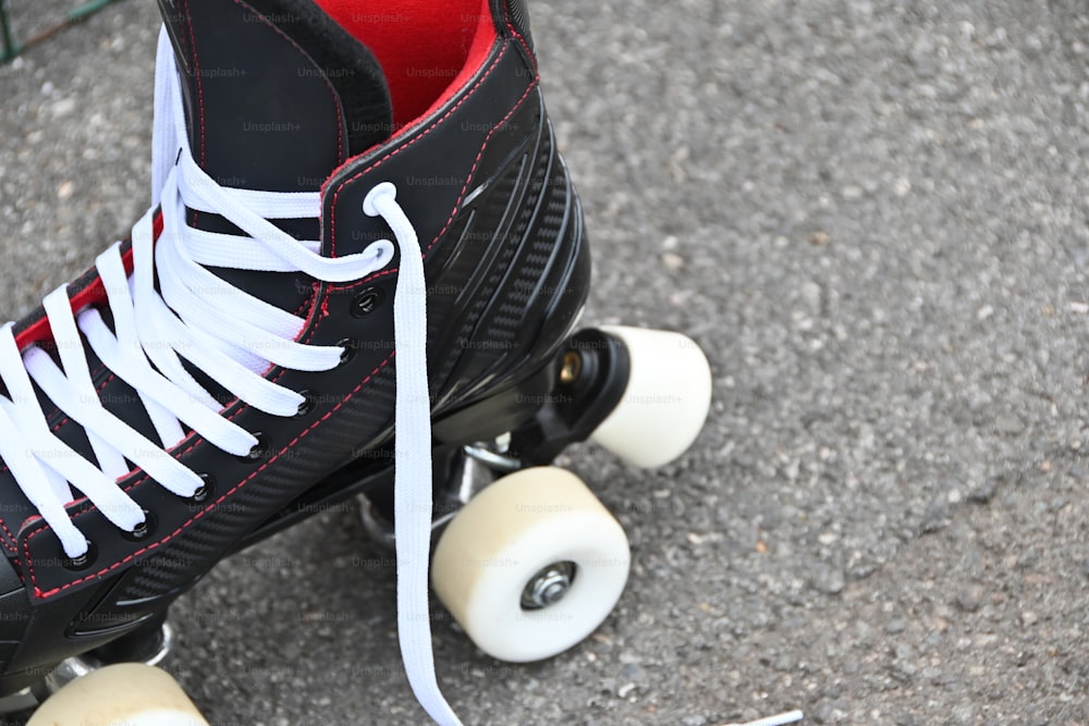 a pair of black and white roller skates with white laces