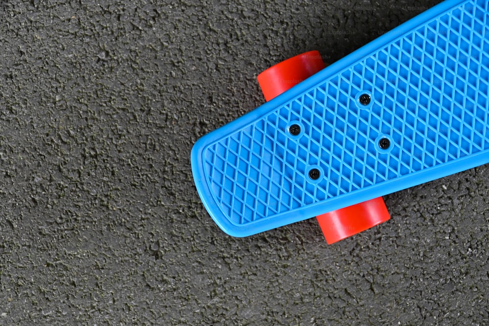 a blue skateboard laying on the ground