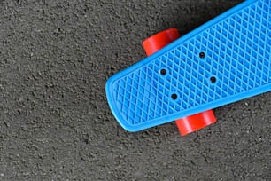 a blue skateboard laying on the ground