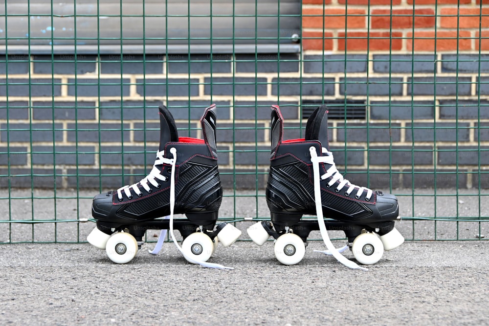 a pair of black roller skates with white wheels