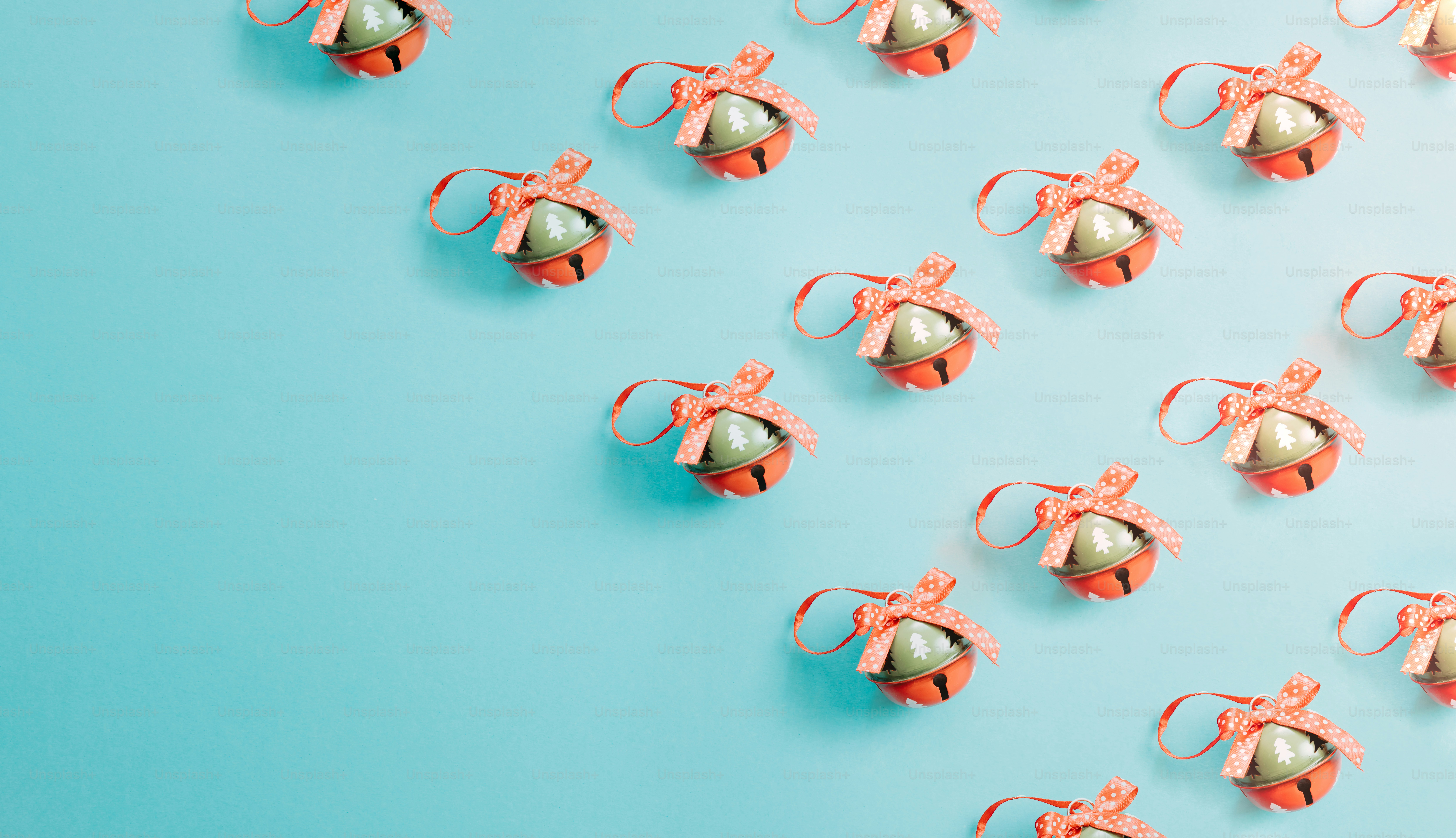 a group of small metal bells sitting on top of a blue surface