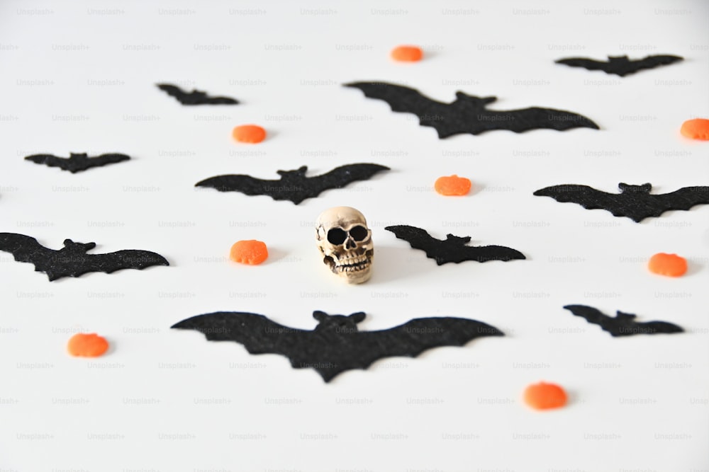 a skull with a skull face surrounded by bats