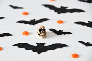 a skull and bats on a white surface