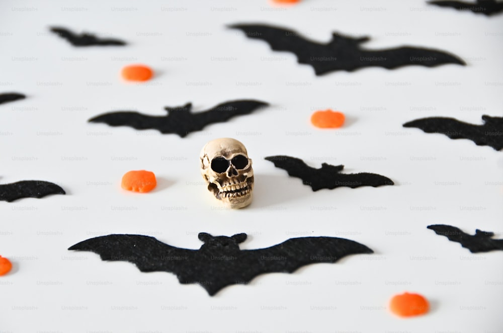 a skull and bats on a white surface